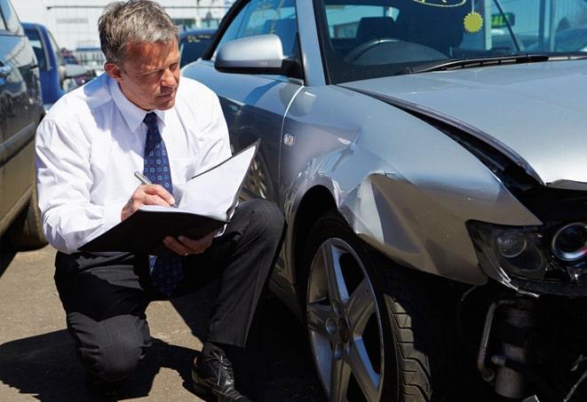 broken car window with insurance paperwork